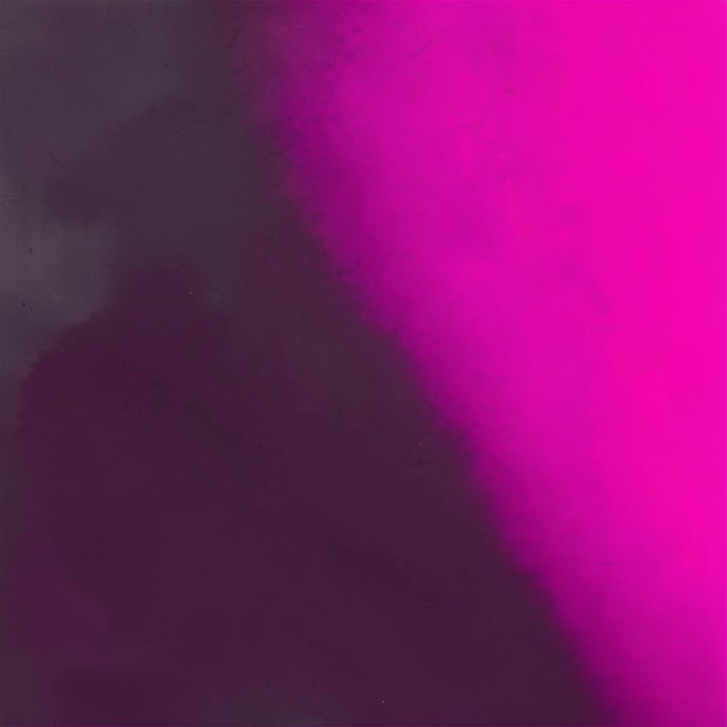 A dark duotone photograph in black and pink of a city skyline silhouette suggesting the location-based grouping of data